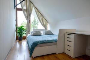 a bedroom with a bed and a dresser and a window at Eva's house in Ivanec +17 photos