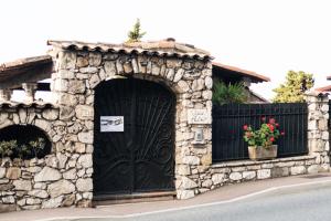 a black door on a stone building with a gate at Villa Azur Cap d'Ail in Cap d'Ail