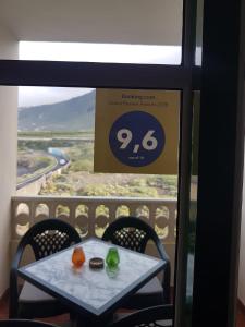 a table in a room with a view from a window at Apartamento Mar y Montaña in Los Silos