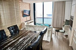 a living room with a bench and a large window at Matrix Luxury Apartments Century City, Cape Town in Cape Town
