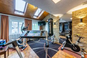 a gym with two exercise bikes and a treadmill at Hotel Krone in Rielasingen-Worblingen