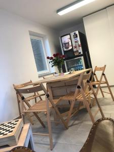 a wooden desk and chairs in a room with a window at Vila Burbonka in Nova Gorica