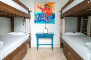 a bedroom with a bed and a desk at La Banda Rooftop Hostel in Seville