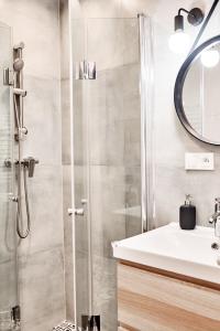 a bathroom with a shower and a sink at Apartamenty Nad Rzeką in Polanica-Zdrój +28 photos