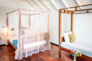 Postel nebo postele na pokoji v ubytování Sirène Galle Fort