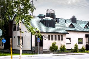 a white building with a green roof at Villa Kemi in Kemi