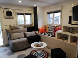 un salon avec un canapé et une télévision dans l'établissement entre mer et montagne, à Peyroules