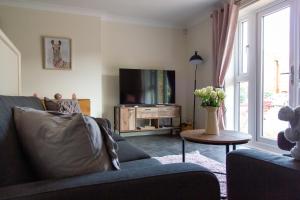 - un salon avec un canapé et une télévision dans l'établissement Waters Edge, à Chester