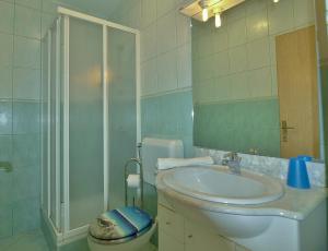 a bathroom with a toilet and a sink and a shower at Apartments Eufemija in Rab +47 photos