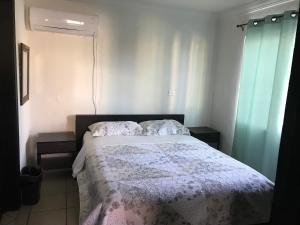 a bedroom with a bed and two pillows on it at Apartamento Siesta Del Sol II in Puerto Peñasco