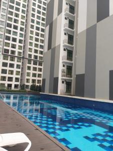 a swimming pool in front of two tall buildings at D Summit Cozy Homestay in Skudai