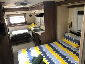 a bedroom with a bed and a desk at Karumba Point Sunset Caravan Park in Karumba