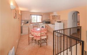 a kitchen with a table and chairs in a kitchen at Cozy Apartment In Castagniers With House A Mountain View in Porcio