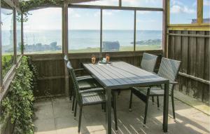 a table and chairs on a balcony with a view of the ocean at Holiday Home Spodsbjergvej I in Spodsbjerg +15 photos