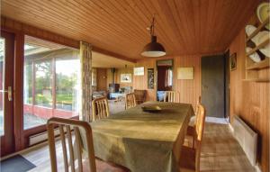 a dining room with a large wooden table and chairs at Holiday Home Odder With A Fireplace 07 in Kysing