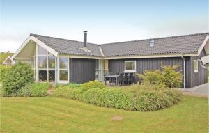 a gray house with a lawn in front of it at Holiday Home Grønkær Høj Vej Haderslev X in Kelstrup Strand