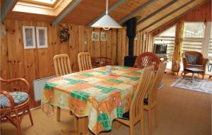 a dining room with a table and chairs at Awesome Home In Oksbl With 2 Bedrooms in Oksbøl