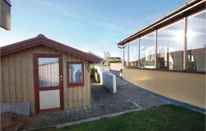 a small building with a door on the side of a building at Two-Bedroom Holiday Home In Haderslev in Store Anslet