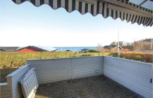 a patio with a white bench and an umbrella at Two-Bedroom Holiday Home In Haderslev in Store Anslet