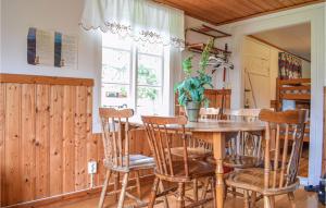 a dining room with a wooden table and chairs at Stunning Home In Vimmerby in Vimmerby