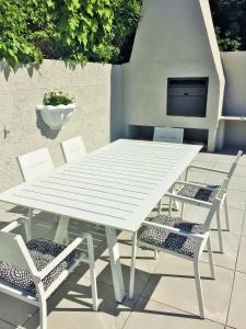 a white picnic table and chairs on a patio at Villa Eike in Grabouw