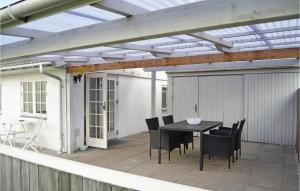 a pergola on a patio with a table and chairs at Awesome Home In Silkeborg With 2 Bedrooms And Wifi in Silkeborg