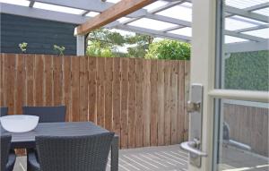 a patio with a table and chairs and a fence at Holiday Home Silkeborg 9 Denmark in Silkeborg