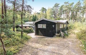 a black shed with two bikes parked next to it at Nice Home In Aakirkeby With 3 Bedrooms And Wifi in Vester Sømarken