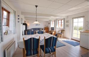 NeksøにあるAmazing Home In Nex With 2 Bedroomsのダイニングルーム、リビングルーム(テーブル、椅子付)