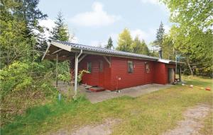 uma cabana vermelha no meio de uma floresta em Awesome Home In Hadsund With Wifi em Helberskov