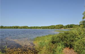 a large body of water with trees in the background at Holiday Home Egelunden Ansager I in Ansager