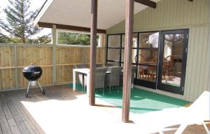 a screened in porch with a grill and a grill at Nice Home In Rm With 3 Bedrooms And Wifi in Bolilmark