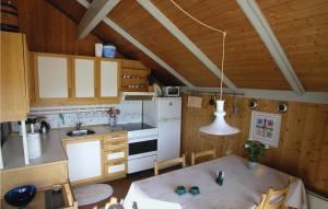 a kitchen with white appliances and a table in a room at 2 Bedroom Lovely Home In Rm in Bolilmark