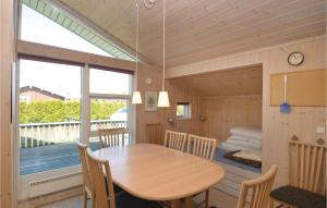a room with a table and chairs and a bed at Holiday Home Elsdyrstien Væggerløse Vi in Marielyst