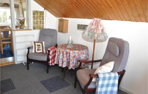 a room with a table and two chairs and a lamp at Three-Bedroom Holiday Home In Broager in Broager
