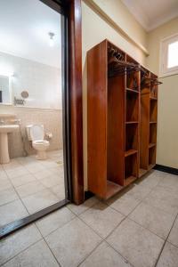 a bathroom with a toilet and a glass door at Stonetown View Hotel in Zanzibar City
