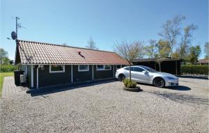 a white car parked in front of a house at Three-Bedroom Holiday Home In Sydals in Skovbyballe