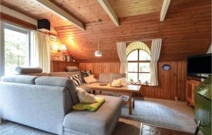 a living room with a couch and a table at Holiday Home Narssagsvej in Bolilmark +12 photos