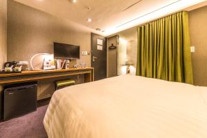 Postel nebo postele na pokoji v ubytování Goodmore Hotel