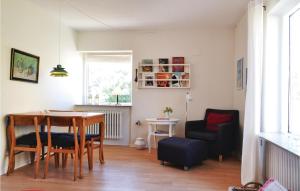 a living room with a dining room table and chairs at Beautiful Home In Nrre Nebel With Wifi in Nymindegab