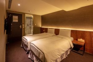 Postel nebo postele na pokoji v ubytování Goodmore Hotel