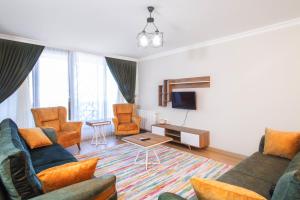 a living room with two couches and a tv at Emin Residence in Istanbul