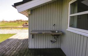 a sink on the side of a house at Holiday Home Strandparken Dnmk Ii in Otterup +12 photos