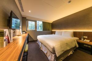Postel nebo postele na pokoji v ubytování Goodmore Hotel