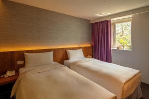 Postel nebo postele na pokoji v ubytování Goodmore Hotel