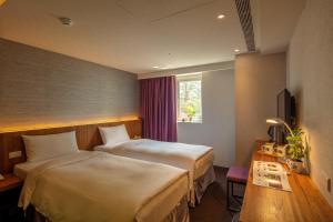 Postel nebo postele na pokoji v ubytování Goodmore Hotel