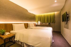 Postel nebo postele na pokoji v ubytování Goodmore Hotel