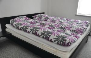 a bed with a purple and white blanket on it at One-Bedroom Apartment In Sydals in Tandslet +4 photos