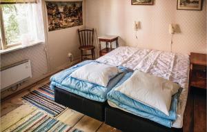 a bedroom with a bed with two pillows on it at 3 Bedroom Lovely Home In Vimmerby in Vimmerby