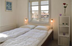two large beds in a room with a window at 3 Bedroom Beautiful Home In Dronningmlle in Dronningmølle